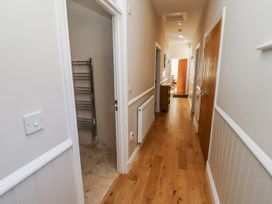A hallway with a door and radiator at Red Fox in Lucker