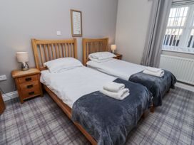 A bedroom with two beds and a nightstand at Red Fox in Lucker