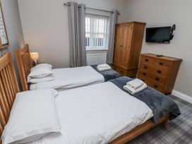 A bedroom with two beds and a wardrobe at Red Fox in Lucker