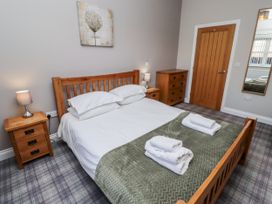 A bedroom with a bed and nightstands at Red Fox in Lucker