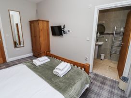 A bedroom featuring a bed and wardrobe at Red Fox in Lucker