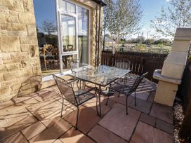 An outdoor patio with a table and chairs at Red Fox in Lucker