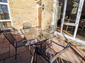 An outdoor seating area with a table and chairs at Red Fox in Lucker
