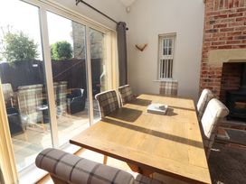A dining room with a wooden table and chairs at Roe Deer in Lucker