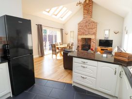 A kitchen with a dining area and fireplace at Roe Deer in Lucker