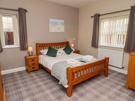 A bedroom with a bed and bedside table at Roe Deer in Lucker
