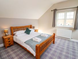 A bedroom with a wooden bed and nightstands at Roe Deer in Lucker
