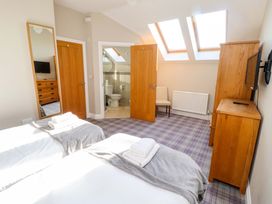 A bedroom with two beds and a television at Roe Deer in Lucker