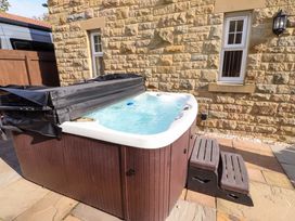 A hot tub with steps in an outdoor area at Roe Deer in Lucker