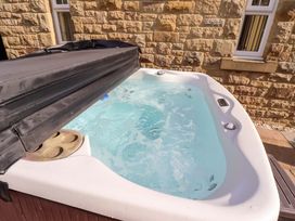 A hot tub with water and cover at Roe Deer in Lucker