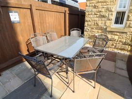 An outdoor patio with a table and chairs at Roe Deer in Lucker