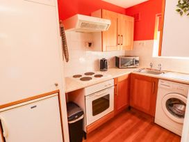 A kitchen with appliances and fixtures at Flora Cottage Beadnell