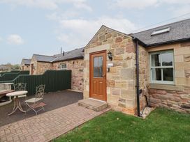 An entrance with a door and patio furniture at Chiff Chaff in Lucker