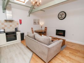 A living room with a sofa and dining table at Chiff Chaff in Lucker