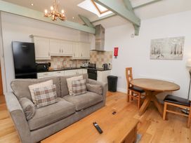 A living room with a sofa and dining area at Chiff Chaff in Lucker