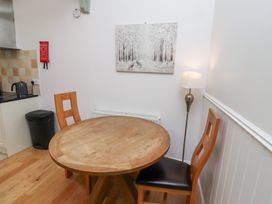 A dining room with a round table and two chairs at Chiff Chaff in Lucker