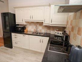 A kitchen with cabinets, sink, and appliances at Chiff Chaff in Lucker