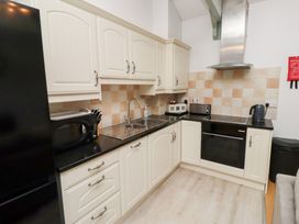 A kitchen with various appliances and cabinets at Chiff Chaff in Lucker