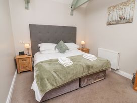 A bedroom with a bed and bedside tables at Chiff Chaff in Lucker