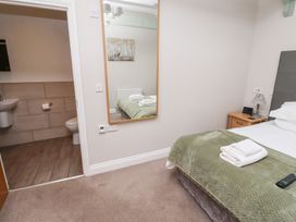 A bedroom with a bed and bathroom access at Chiff Chaff in Lucker