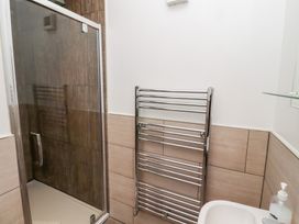 A bathroom with a shower and towel rail at Chiff Chaff in Lucker
