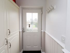 A hallway with a door and storage cabinets at Chiff Chaff in Lucker
