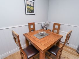 A dining room with a table and chairs at Rosefinch in Lucker