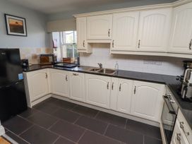 A kitchen with sink and appliances at Rosefinch in Lucker