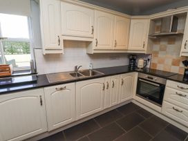 A kitchen with cabinets and appliances at Rosefinch in Lucker