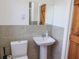 A bathroom with a sink and toilet at Rosefinch in Lucker