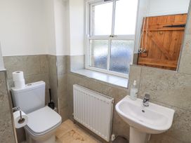 A bathroom with a toilet and sink at Rosefinch in Lucker