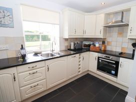 A kitchen with cabinets and appliances at Chaffinch in Lucker