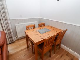 A dining room with a wooden table and chairs at Chaffinch Lucker
