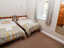 A bedroom with two beds and a window at Chaffinch in Lucker