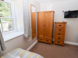 A bedroom with a wardrobe and chest of drawers at Chaffinch in Lucker