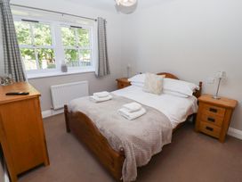 A bedroom with a bed and bedside tables at Chaffinch in Lucker