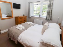 A bedroom with a bed and a chest of drawers at Chaffinch in Lucker