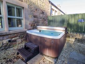 A hot tub with steps outside at Goldfinch in Lucker
