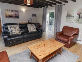 A living room with a sofa and armchair at Goldfinch in Lucker