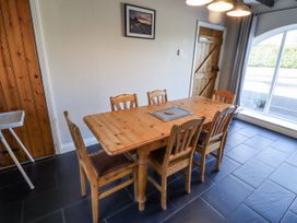 A dining room with a wooden table and chairs at Goldfinch in Lucker