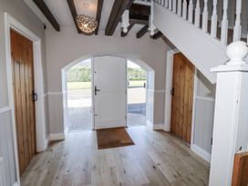 A hallway with front door and staircase at Goldfinch in Lucker
