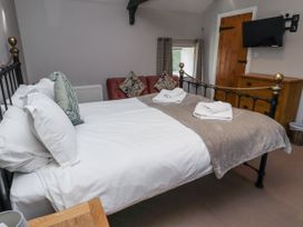 A bedroom with a bed and a television at Goldfinch in Lucker