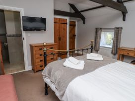 A bedroom with a bed and television at Goldfinch in Lucker