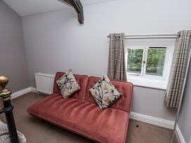 A snug with a sofa and window at Goldfinch in Lucker