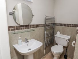 A bathroom with a sink, toilet, and towel rail at Goldfinch in Lucker