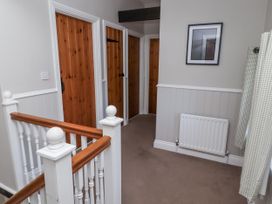 A hallway with wooden doors and a radiator at Goldfinch in Lucker