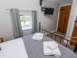 A bedroom with a bed and television at Goldfinch in Lucker