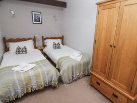 A bedroom with two beds and a wardrobe at Goldfinch in Lucker