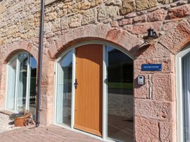 An entrance with a brown door and a sign at Bullfinch in Lucker