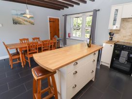 A kitchen with dining table and chairs at Bullfinch in Lucker